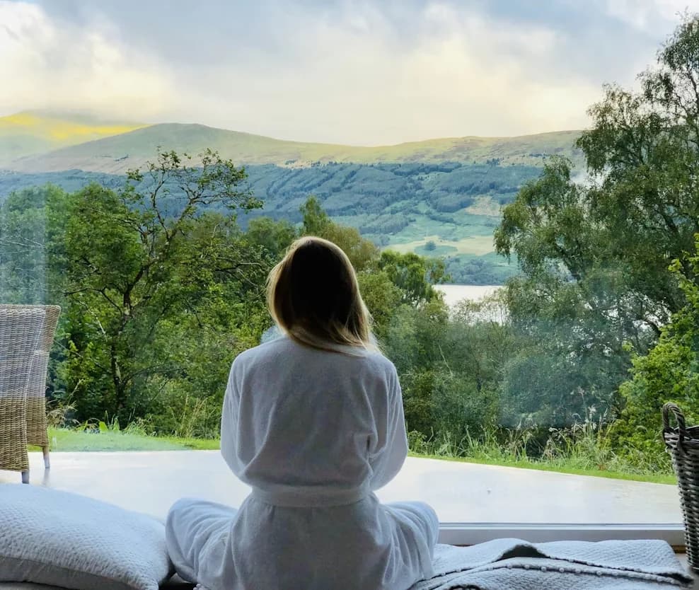 A person looking over a peaceful countryside view